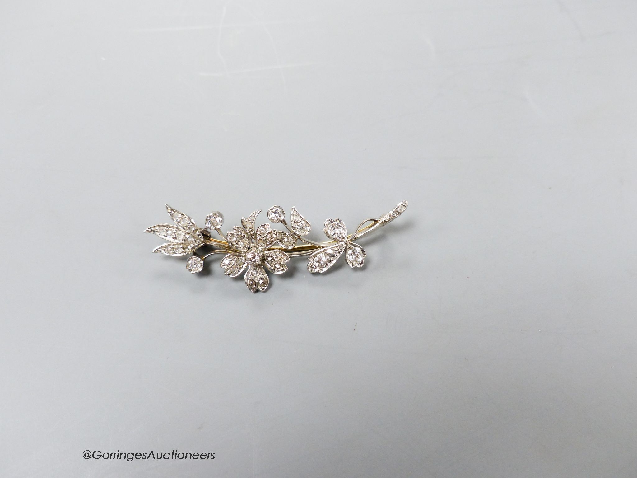 A mid 20th century white metal and diamond set floral spray brooch, 52mm, gross weight 8.3 grams.